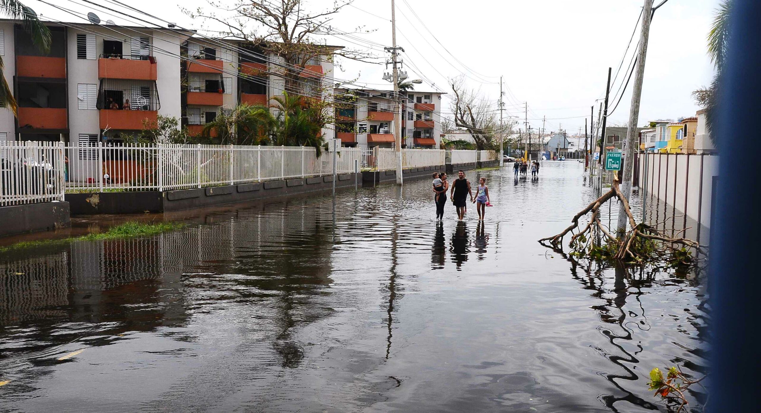Residents walk in flooded streets