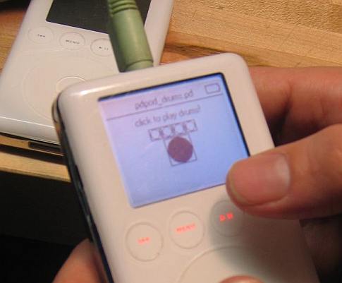 A person holding a white iPod.