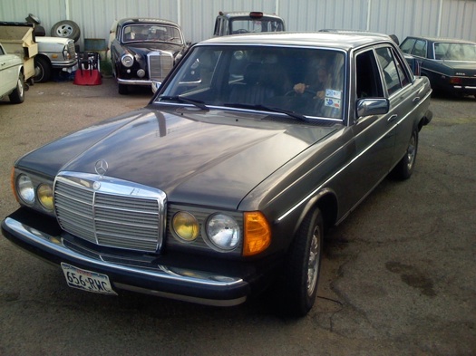 A black Mercedes-Benz in a parking lot.