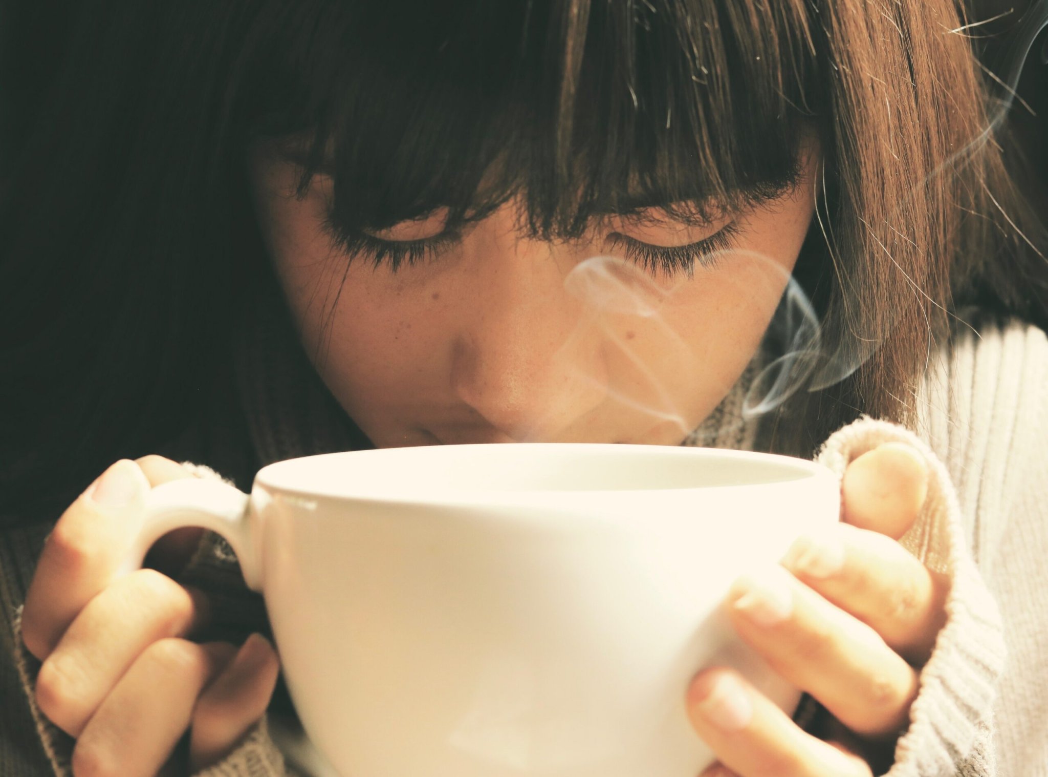 person smelling coffee