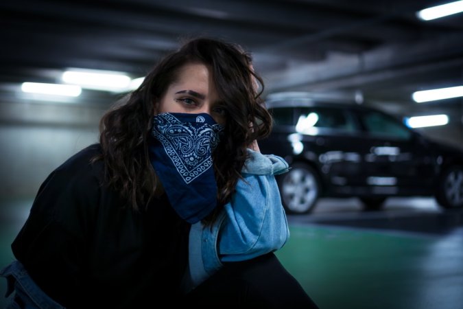 a girl wearing a bandana around her face