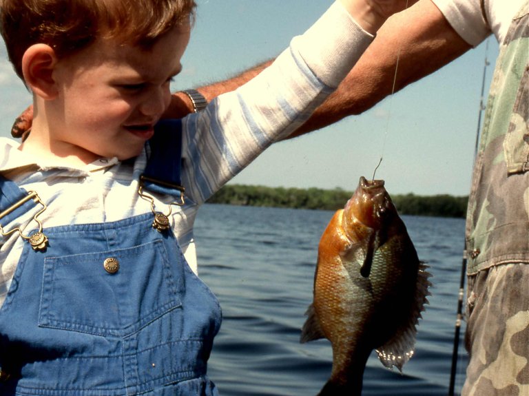 Angler holding up a panfish.