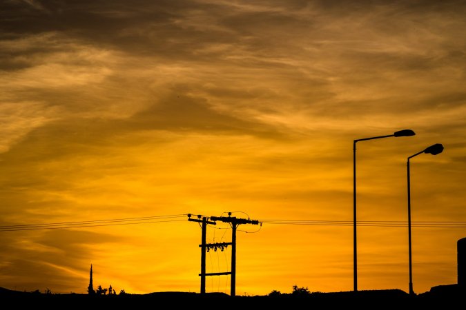 power line silhouette against reddish sunset