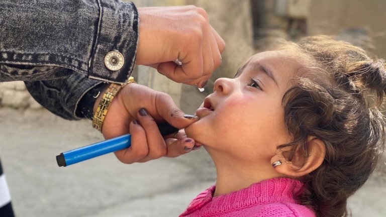 young girl receiving polio vaccine