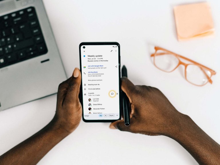 Hands holding phone showing Google calendar chat feature on screen
