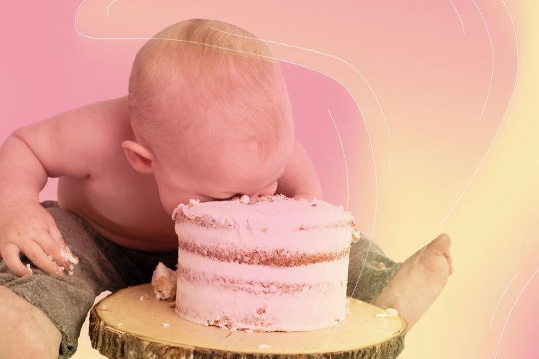 a baby puts their face in a frosted cake