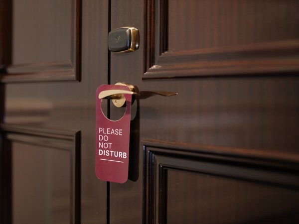 A do not disturb sign on a wooden door. It's the analog way to ensure you have notifications silenced.