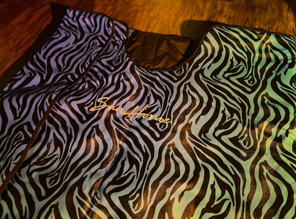  A zebra print Sun Home Saunas blanket on a dark wood floor