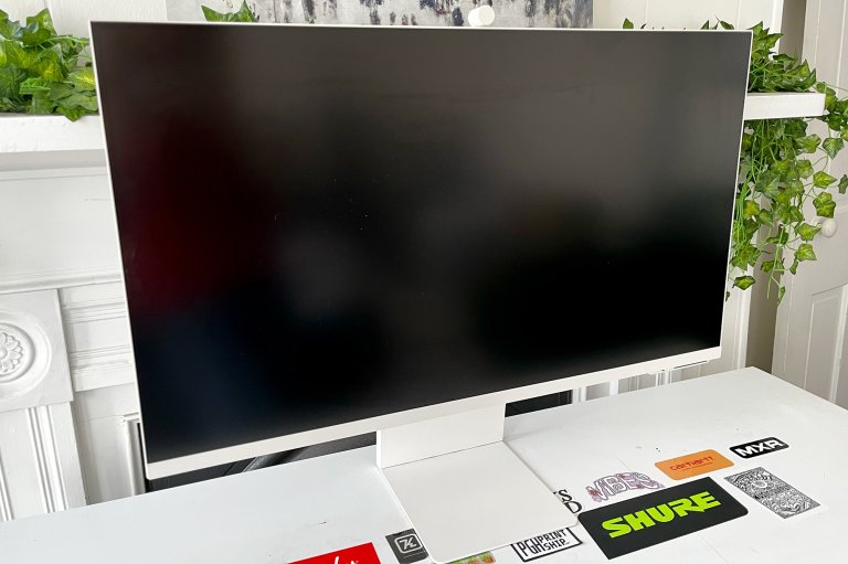 A white Samsung M8 on a white desk