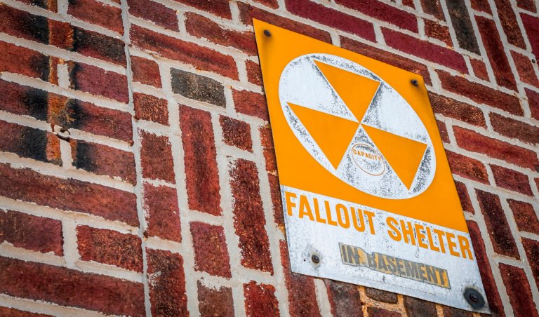 Nuclear shelter basement sign on brick building to represent survival tips for a nuclear blast