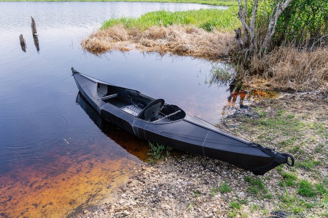 The Oru Beach LT Sport kayak on the shore of a lake