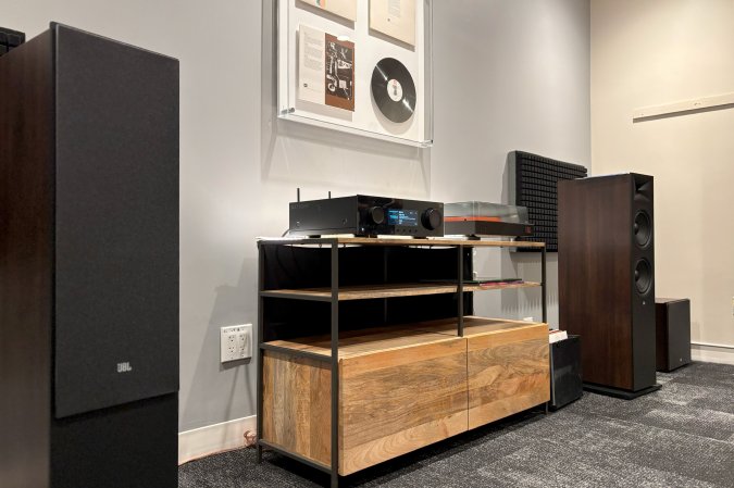  Espresso JBL Stage 2 floorstanding speakers sitting in a demo room at the Harman Experience Center in Los Angelese