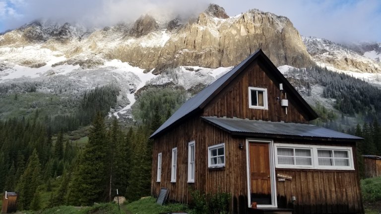a brown building against mountain backdrop