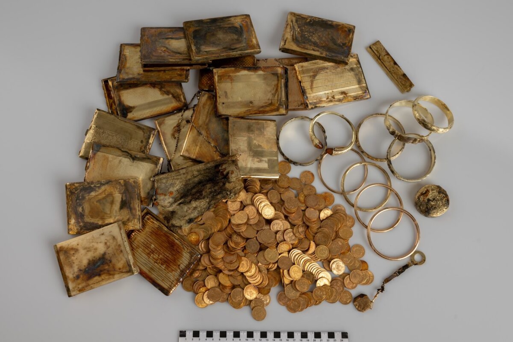 Pile of historic gold coins and other personal objects